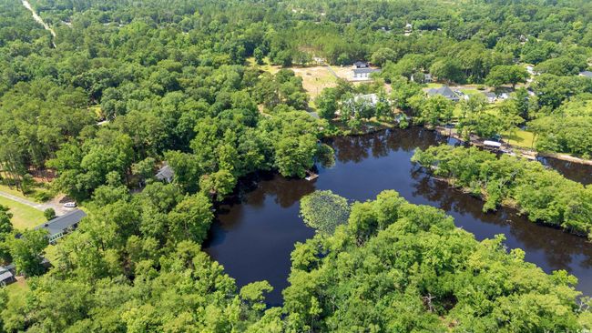 View of property location with a forest and a nearby body of water | Image 39