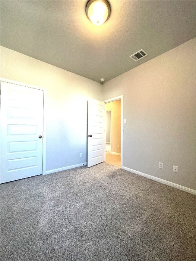 Unfurnished bedroom featuring carpet and a textured ceiling | Image 17