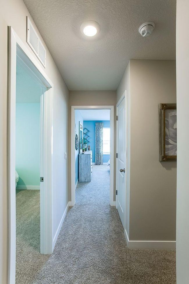 The upper-level hall to three bedrooms and two baths! Photos of model home. Colors and options may vary. Ask Sales Agent for details. | Image 19