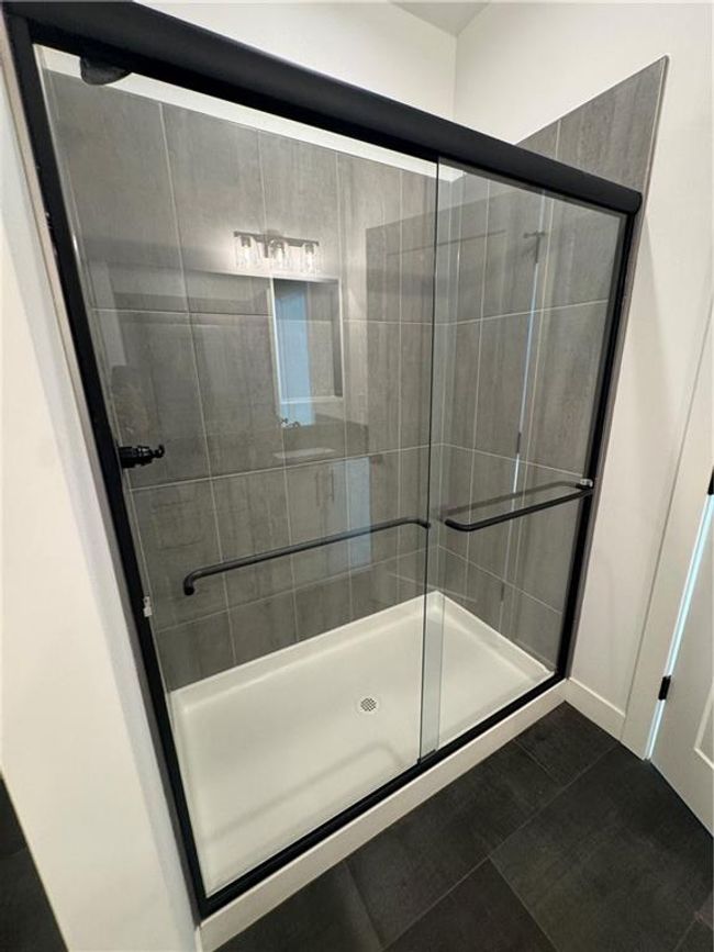 Full bathroom featuring tile patterned flooring and a stall shower | Image 18