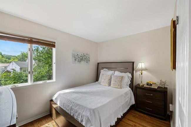 Bedroom with dark hardwood / wood-style floors | Image 13