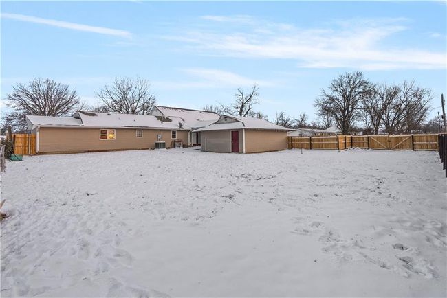 Snow covered property featuring central AC unit and an outdoor structure | Image 53