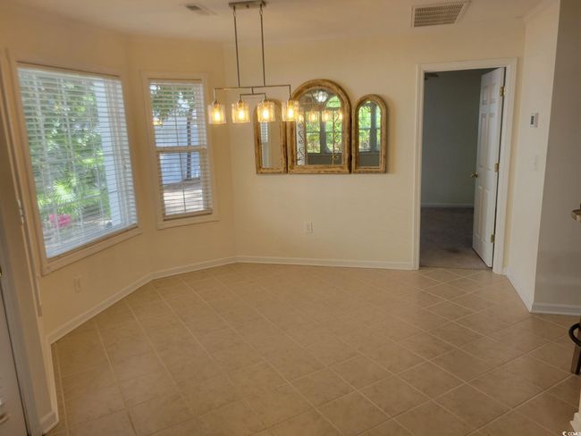 Unfurnished room with healthy amount of natural light and light tile patterned flooring | Image 11