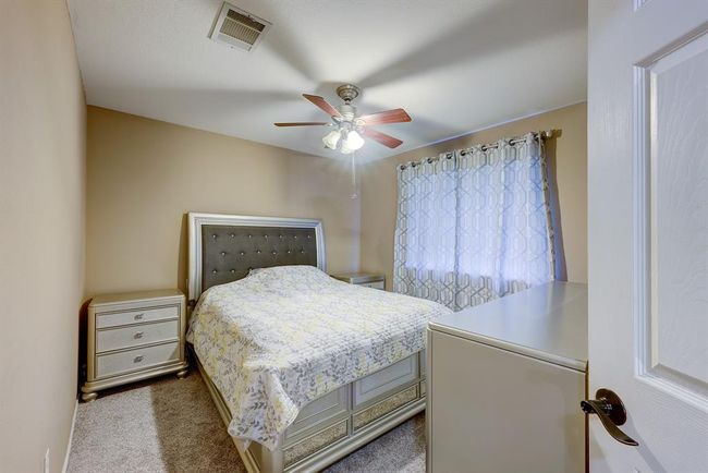 Bedroom featuring dark colored carpet and a ceiling fan | Image 15