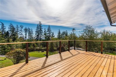 New cedar deck with stainless steel tension wire railing. You will feel on top of the world with gorgeous territorial and partial water views. The deck even has a propane hookup for a BBQ | Image 2