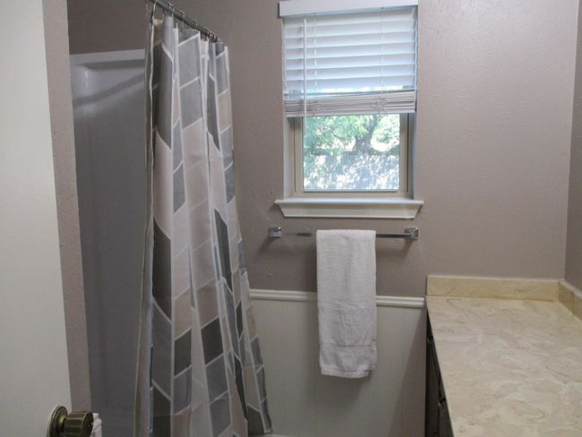 Full bathroom with vanity and a shower with curtain | Image 8