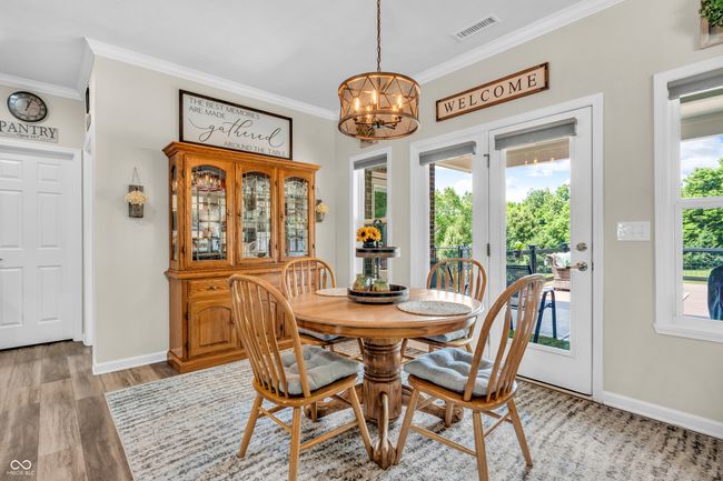 dining area leads to covered patio, trek deck w/cable railing and hot tub | Image 27