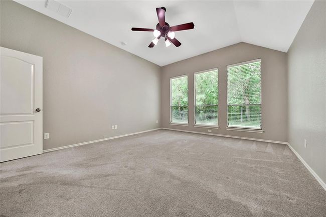 The spacious owner's suite accommodates large furniture. | Image 18