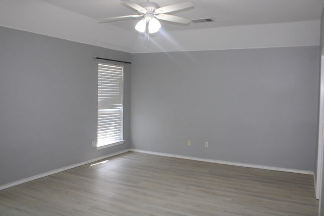 Empty room with visible vents, light wood-type flooring, a ceiling fan, and baseboards | Image 20