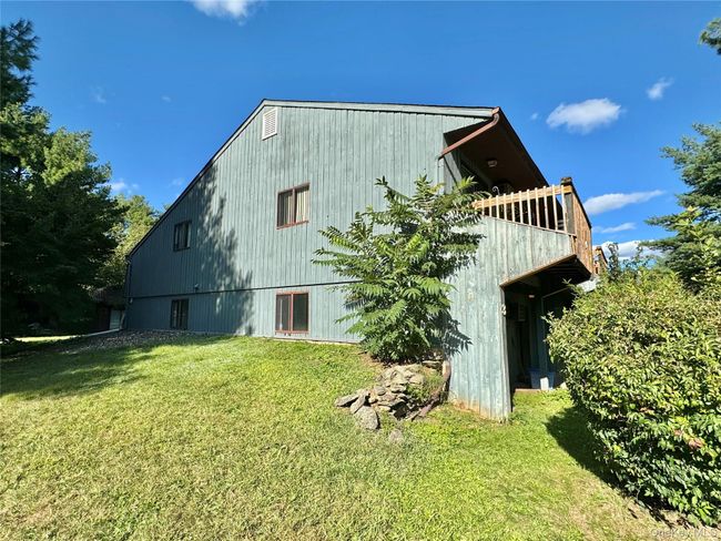Rear view of property featuring a yard | Image 20