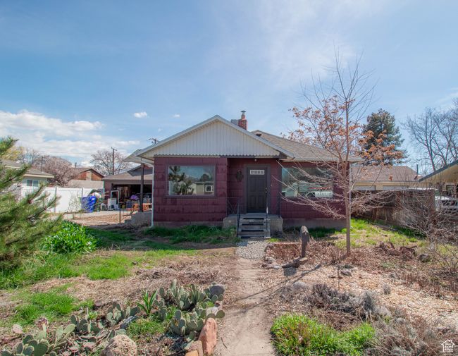 Front view of property with fence, a chimney, and a shingled roof | Image 19