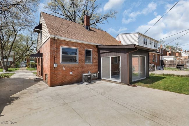 Rear view of property featuring a patio, a chimney, central AC, brick siding, and fence | Image 29