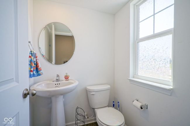 half bathroom with plenty of natural light | Image 7