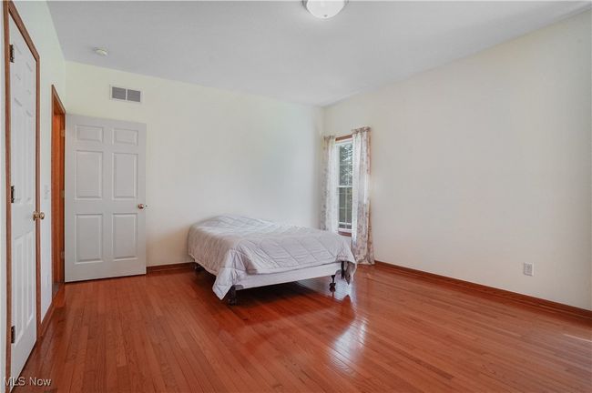 Bedroom featuring visible vents and wood finished floors | Image 30