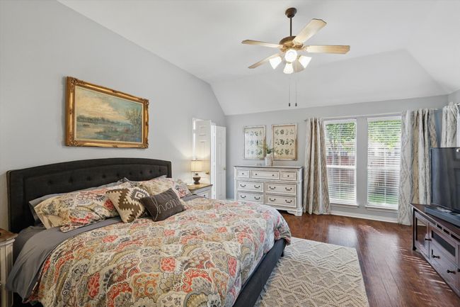 Bedroom featuring lofted ceiling, wood finished floors, and ceiling fan | Image 14