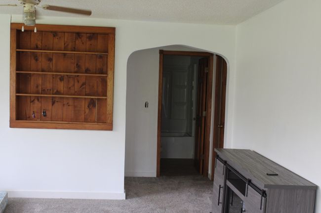 back wall living room with wood shelfs | Image 6