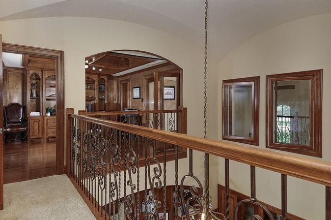 Elegant upstairs hallway with wrought iron railing | Image 26