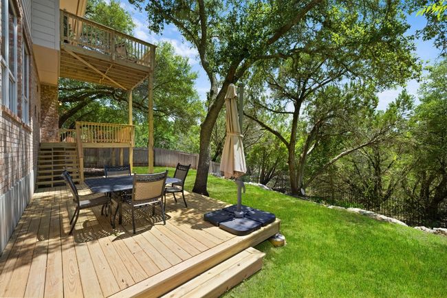 The back deck offers a true outdoor living space—room for dining, lounging, and hosting, all with the greenbelt as your backdrop *Virtual green grass | Image 30