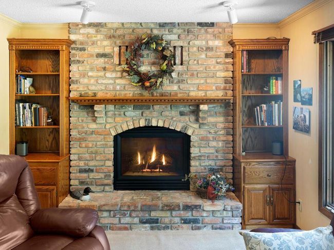 The main floor Family room spotlights a cozy wood-burning fireplace with full brick surround - hearth to ceiling | Image 20