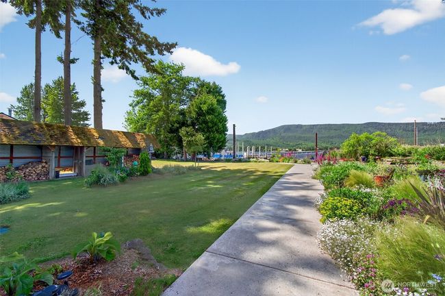 Walkway from house to river. Notice the wood storage building on left. All wood graciously supplied by river. No need to go out and find firewood. It comes to you. | Image 10