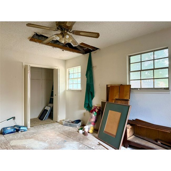 Bedroom 2 featuring multiple windows, and ceiling fan. Bedroom is on front side of house | Image 24