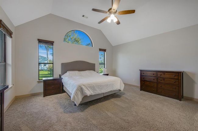 The owners retreat offers comfort, relaxation, high ceiling, plush carpet, ceiling fan, plenty of room and beautiful views of the backyard | Image 21