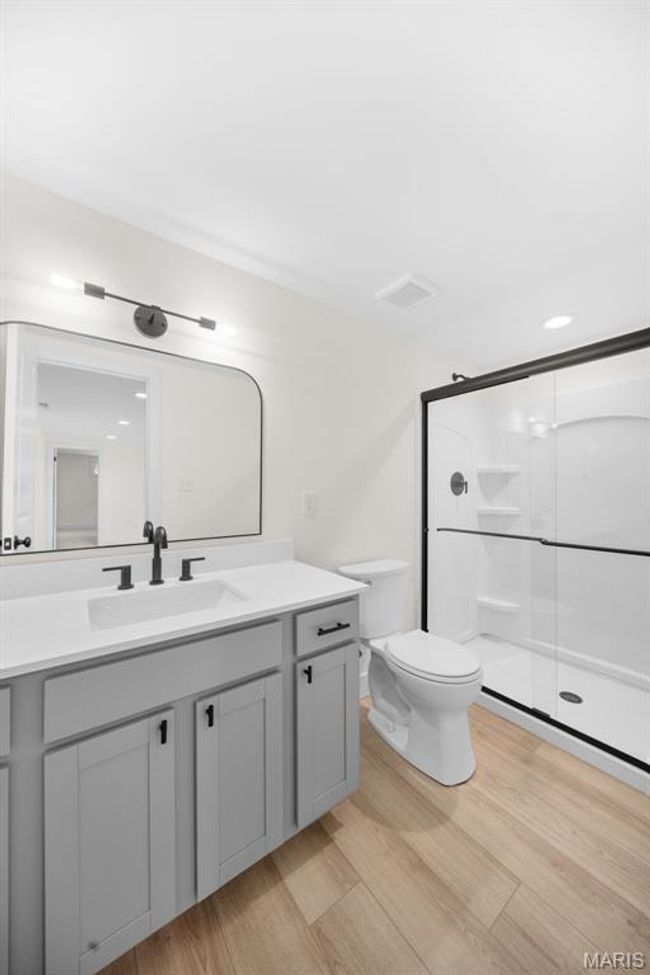 Full bathroom with vanity, a shower stall, and wood finished floors | Image 40