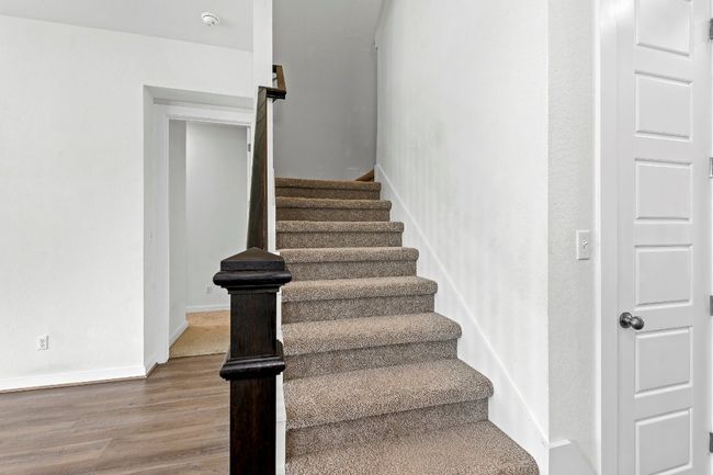 Staircase featuring wood finished floors | Image 25