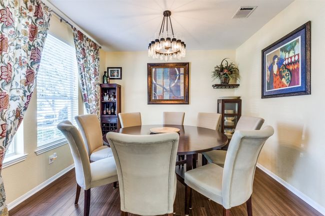 Dining room with baseboards, dark wood-type flooring, and healthy amount of natural light | Image 4