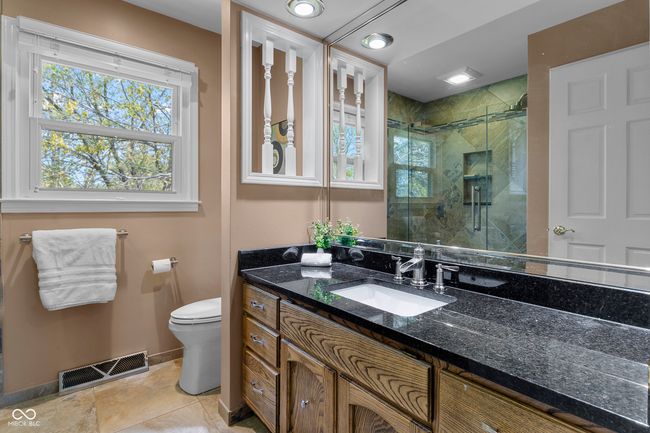 Primary bath with granite counter, full tile walk-in shower and frameless door | Image 25