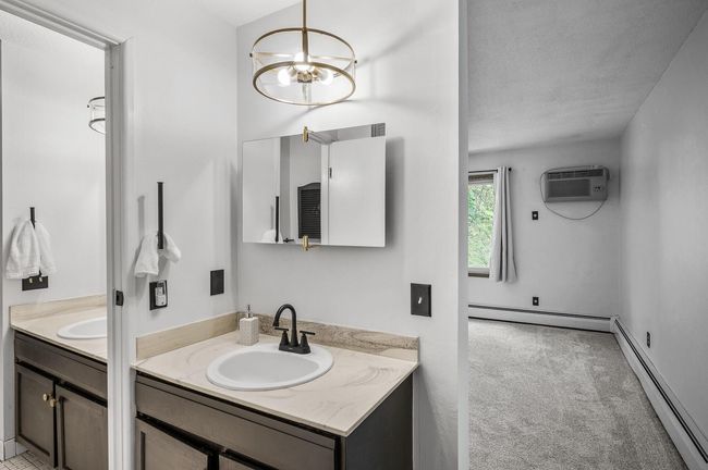 The primary bedroom offers convenient direct access to the full walk-through bathroom with a separate vanity. | Image 16