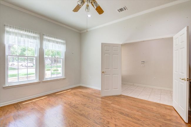 Primary room featuring ceiling fan, light wood finished floors, and crown molding | Image 7