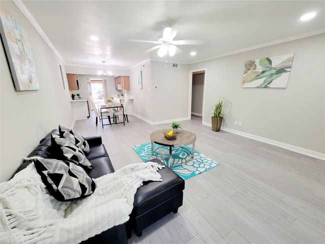 Sitting room with light hardwood / wood-style floors, ceiling fan, and crown molding | Image 8