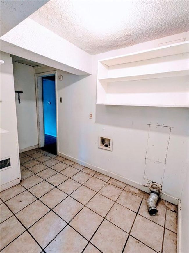Laundry room featuring a textured ceiling, light tile patterned floors, and washer hookup | Image 15