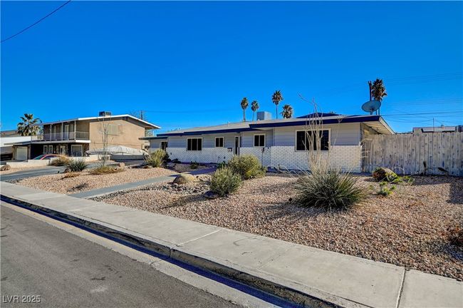 Ranch-style home featuring brick siding and fence | Image 4
