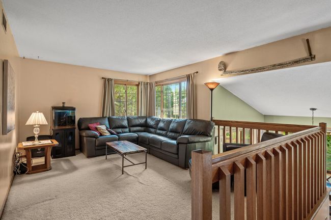 The upper level features neutral colors, plush carpet and an abundance of natural light streaming through the large windows. | Image 6