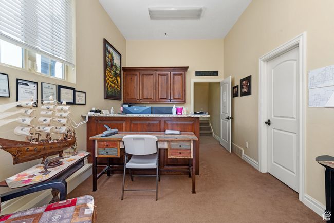 Office area with baseboards and light colored carpet | Image 44