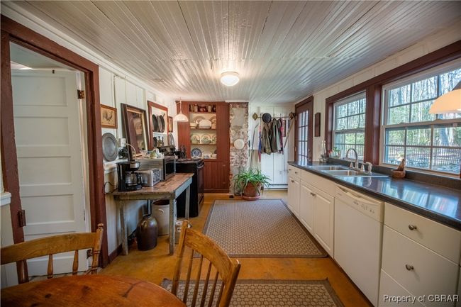 Kitchen featuring a sink, dark countertops, black / electric stove, wooden ceiling, and white dishwasher | Image 9