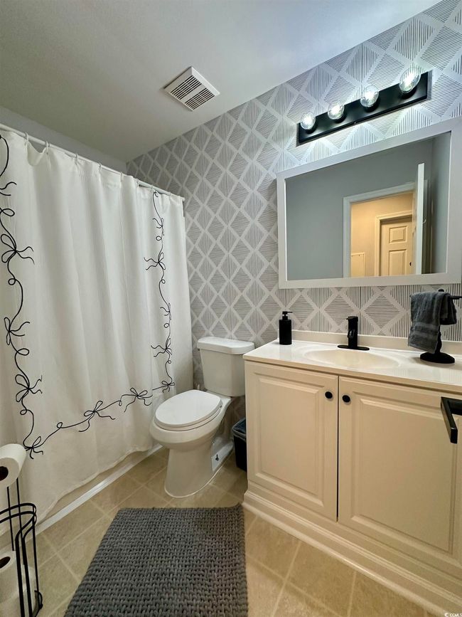 Full bathroom featuring double vanity, tile patterned floors, and baseboards | Image 17