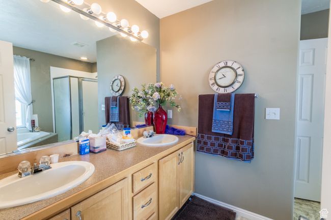 Full bath with a bath, a shower stall, double vanity, and a sink | Image 14