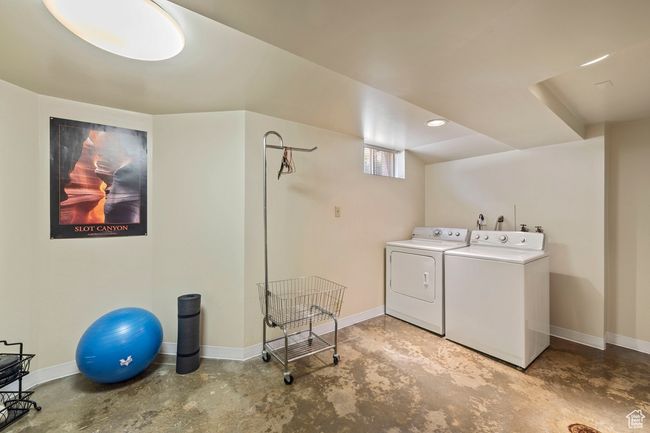 Washroom with washing machine and clothes dryer and baseboards | Image 18