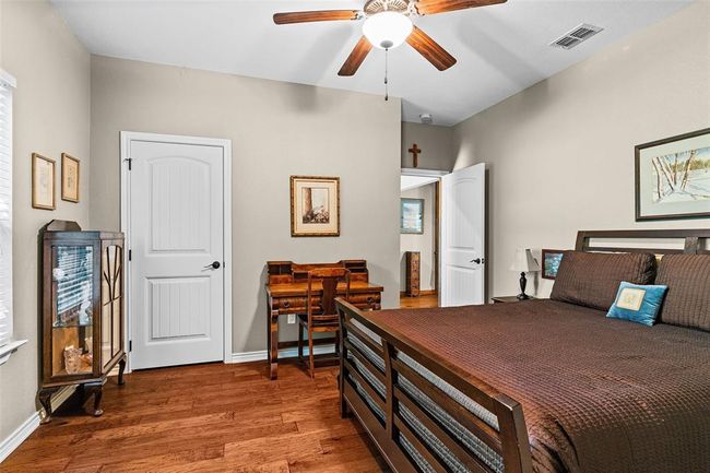 Bedroom featuring hardwood / wood-style flooring and ceiling fan | Image 12