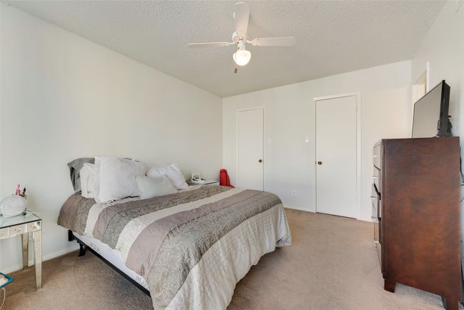 Carpeted bedroom featuring ceiling fan and a textured ceiling | Image 12