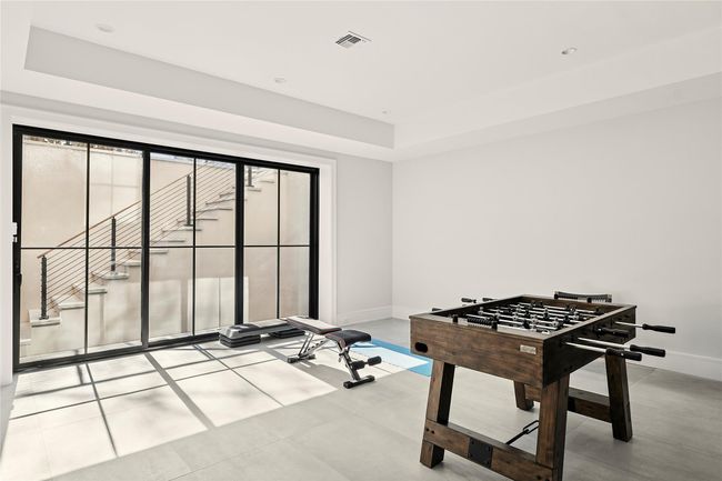 Recreation room featuring baseboards and a raised ceiling | Image 37