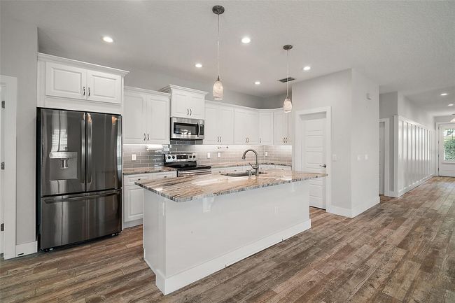 A dream kitchen, with Granite, gleaming appliances, tile backsplash and walk in pantry | Image 9