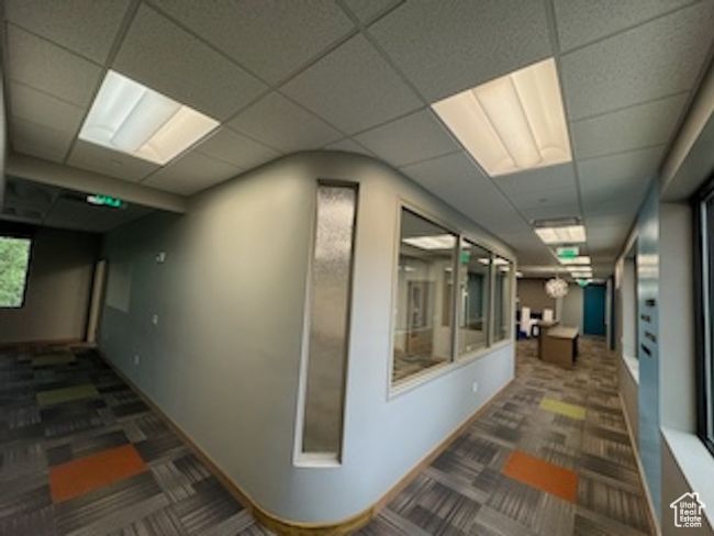 Hallway featuring a drop ceiling and carpet floors | Image 24