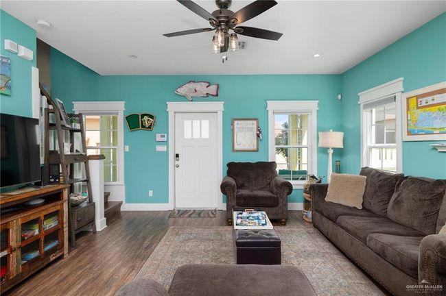 Living room featuring ceiling fan and dark hardwood / wood-style flooring | Image 6