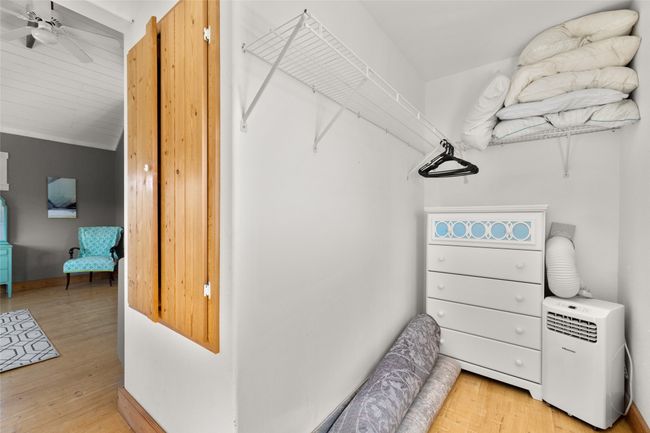 Spacious closet featuring vaulted ceiling, light wood-style flooring, and a ceiling fan | Image 19