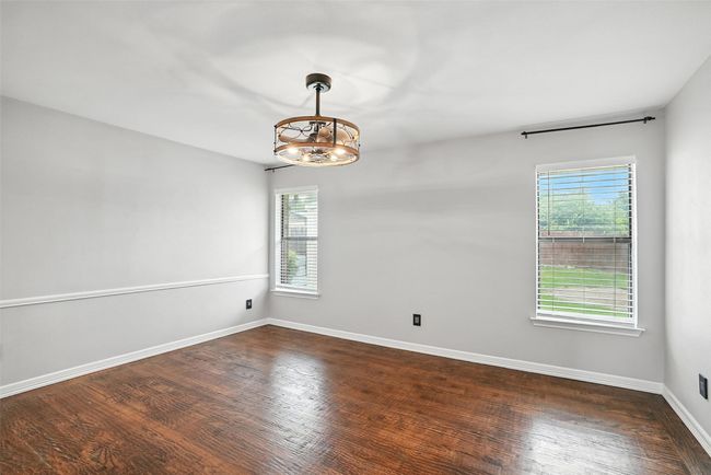 Unfurnished room featuring a chandelier, healthy amount of natural light, and wood finished floors | Image 17