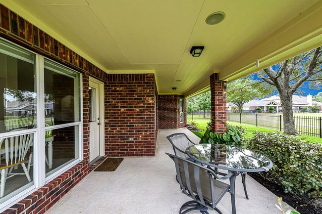 Expansive covered patio and private backyard offers a serene retreat for outdoor living. | Image 20